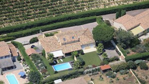 An aerial view of a residential area with multiple houses, a swimming pool, and well-maintained gardens. - Charming villa with heated pool in quiet, 6/8 people, Gulf of St Tropez (Le Plan-De-La-Tour)