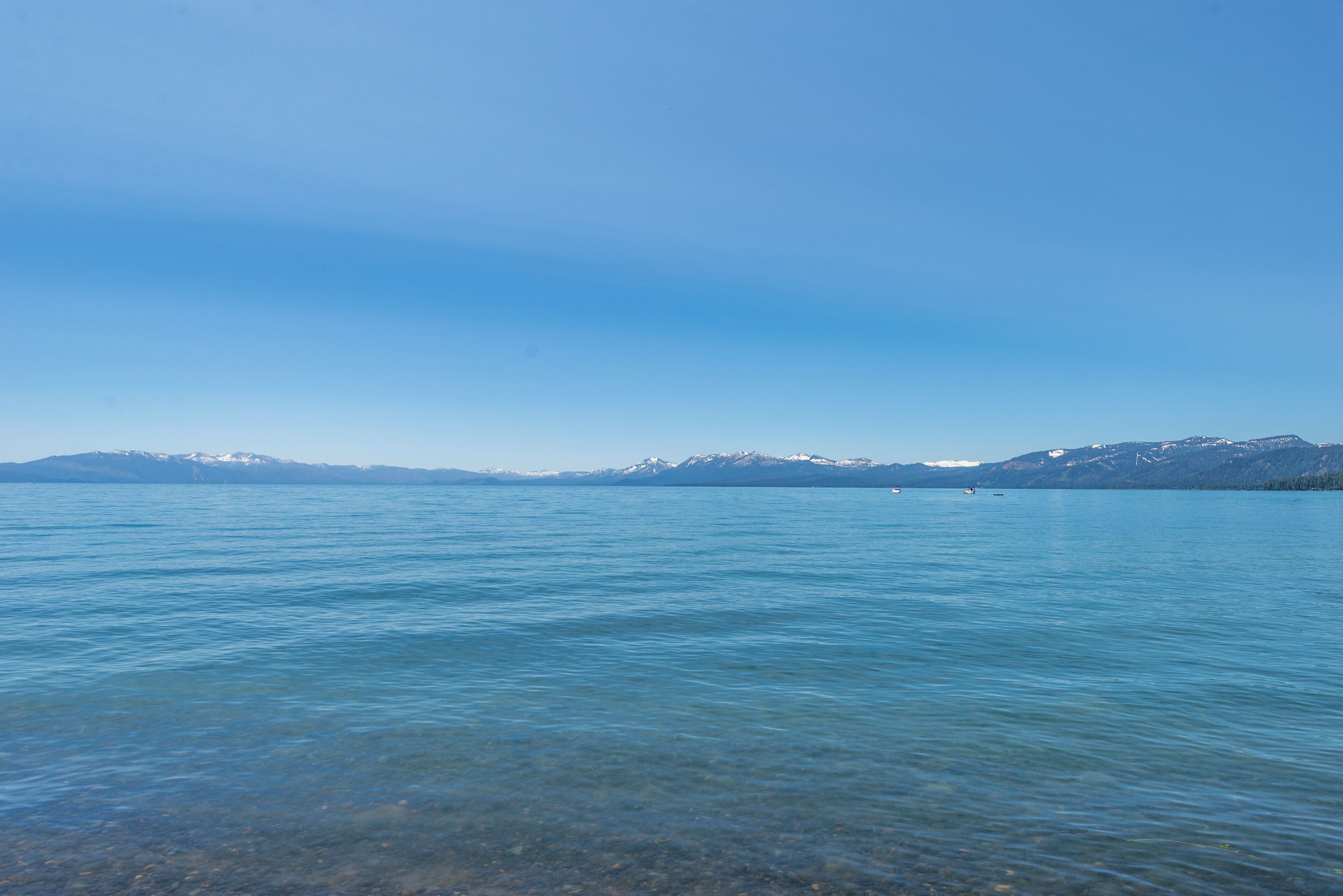 A clear view of a lake with mountains in the background.