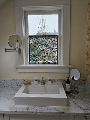 A bathroom with a large window, a sink, and two mirrors. -  Gracious and spacious craftsman house seaside and cityside in Kitsilano. (Vancouver)