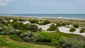 A coastal landscape with a beach, dunes, and a pathway leading to a structure. - Beautiful Oceanfront Condo With Breathtaking Beach Views , 3RD floor, C117 (Fernandina Beach)