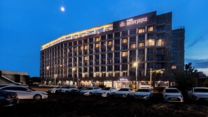 A multi-story hotel with a prominent sign reading "The Best Hotel". - The Best Jeju Seongsan Hotel (Seogwipo)