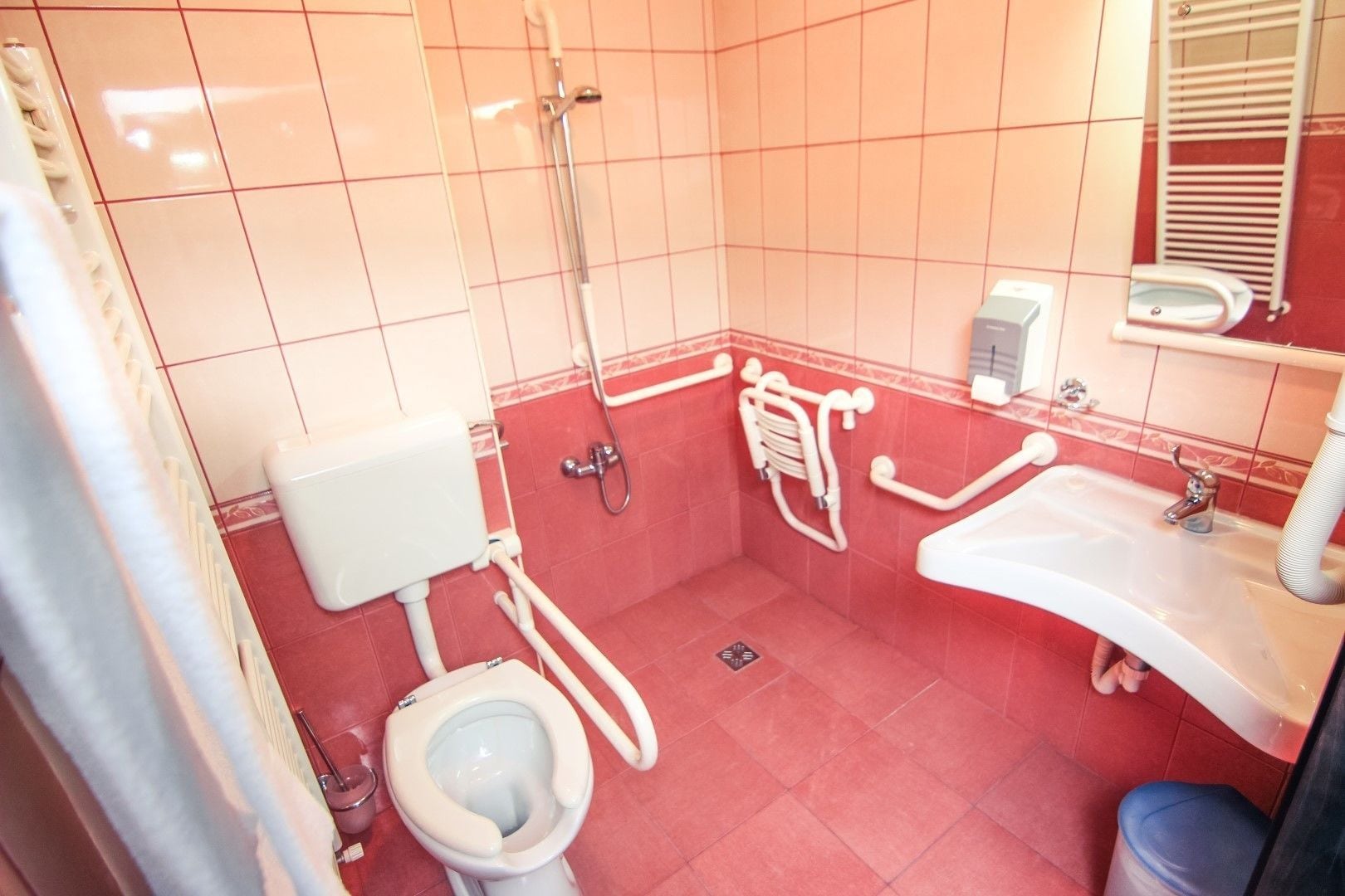 A bathroom with a toilet, sink, and shower.