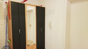 A room with a wardrobe, a mirror, a mop, and a bucket. - At the gates of Hamburg in the old country (Mittelnkirchen)