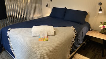 Relax in a cozy space with a large bed, nightstand, and framed artwork.