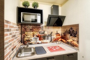 Fridge, electric kettle, cookware/dishes/utensils