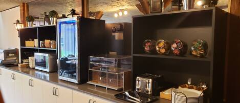 A modern kitchen with a built-in microwave, toaster, and a glass display case.