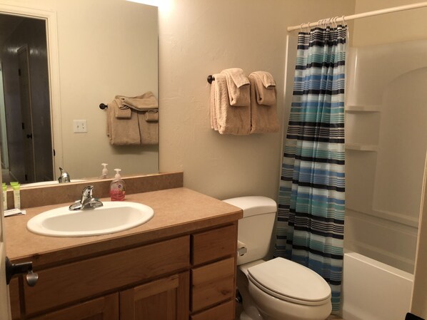 A bathroom with a sink, mirror, towel rack, and toilet. - Moab Horsethief House - 3B/2.5B - Garage - Pool (Moab)