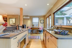Prepare meals in the central island kitchen with a stove and ample counter space, then dine in the adjacent seating area.