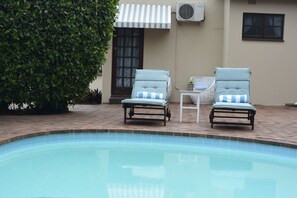 Outdoor pool, open 7:00 AM to 6:30 PM, pool umbrellas, pool loungers