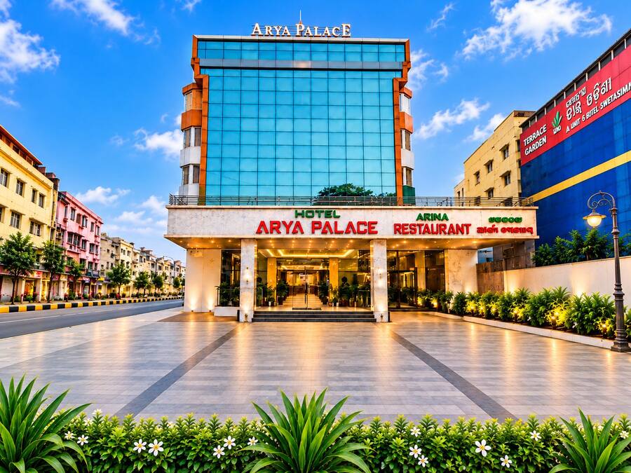 A hotel named Arya Palace with a modern glass facade, a terrace garden, and an Arina restaurant.