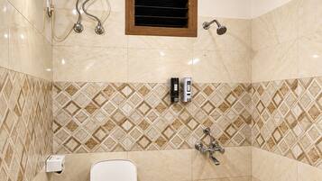 A bathroom with a white toilet, a shower, and a wall-mounted heater.