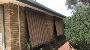 A building with a brick exterior, numbered 20, and a pathway leading to the entrance. - Grantian, Bacchus Marsh (Bacchus Marsh)