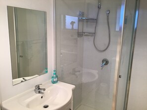 Shower, hair dryer, towels, toilet paper