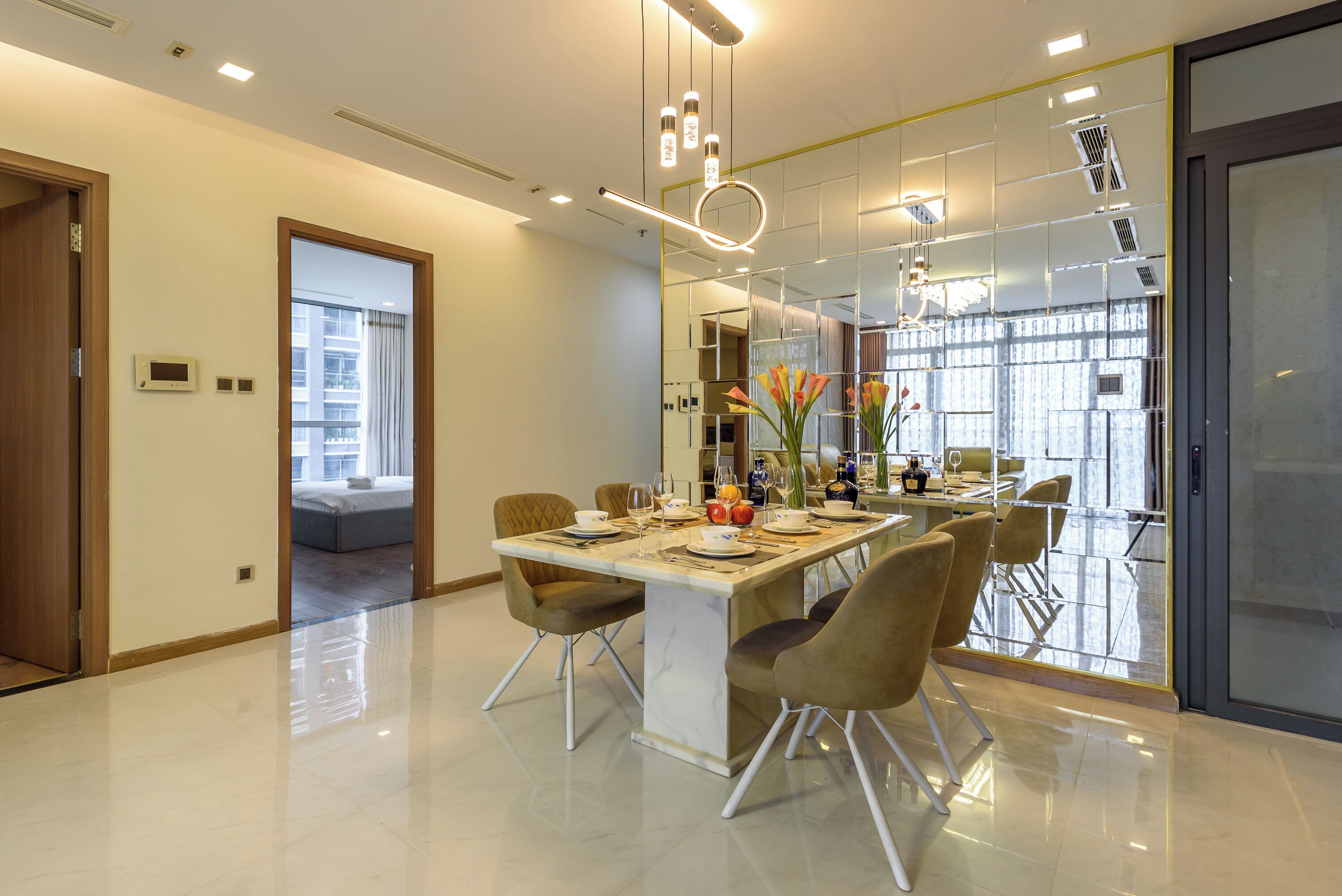 A modern dining area with a marble table, comfortable chairs, and a decorative centerpiece.