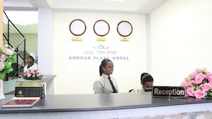 A hotel reception desk with clocks displaying Washington, Ethiopia, and London times. - Gondar Plaza Hotel (Gondar)