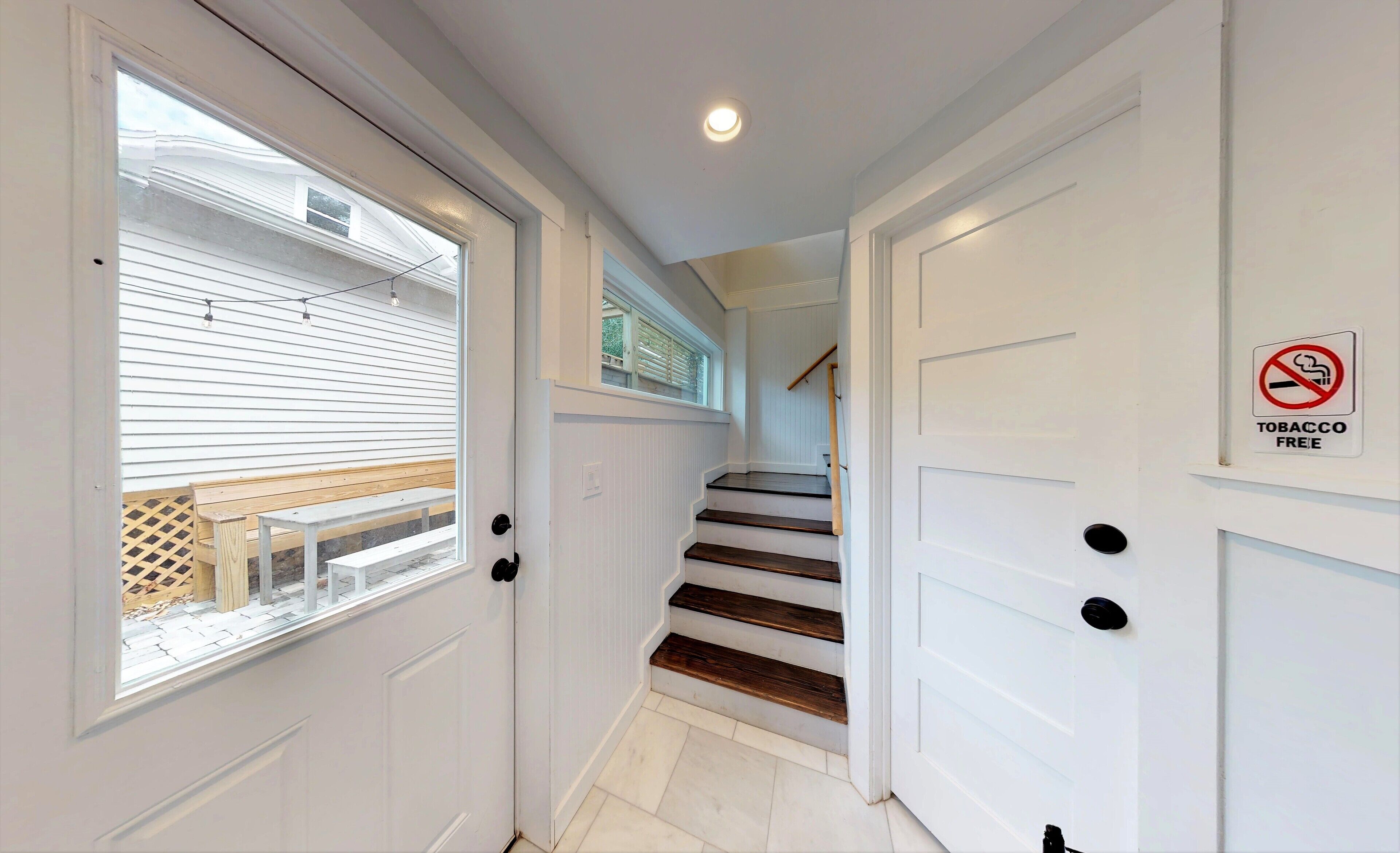 A staircase with white doors and a 'No Smoking' sign.