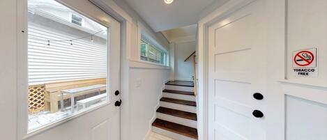 A staircase with white doors and a 'No Smoking' sign.