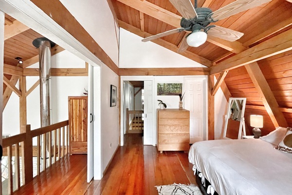 Upstairs bedroom with King size bed and loft office connected by barn doors.