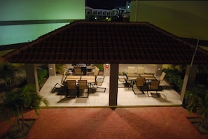 Guests can dine or socialize in this patio area with tables and chairs.