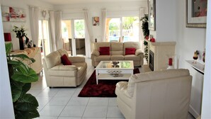 A living room with two sofas, a coffee table, and a fireplace. - Beautifully Furnished Family Villa with Spectacular Views and Pool.  (Moriara)