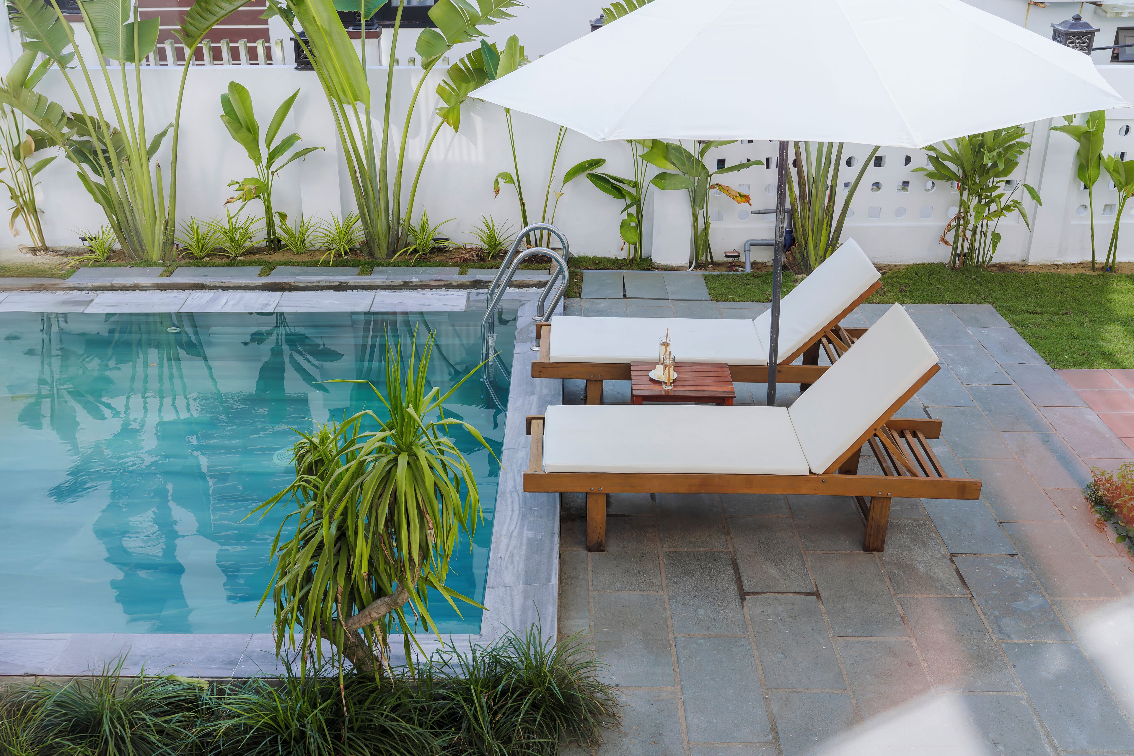 Outdoor pool, open 8:00 AM to 8:00 PM, pool umbrellas, pool loungers