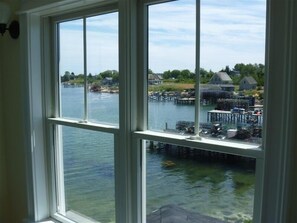 Enjoy breathtaking views of the waterfront from this room's expansive window.