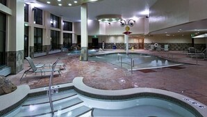 A large indoor swimming pool with multiple lanes, lounge chairs, and a central fountain. - Breckenridge Christmas & New Year weeks 2021-2022 email (Breckenridge)