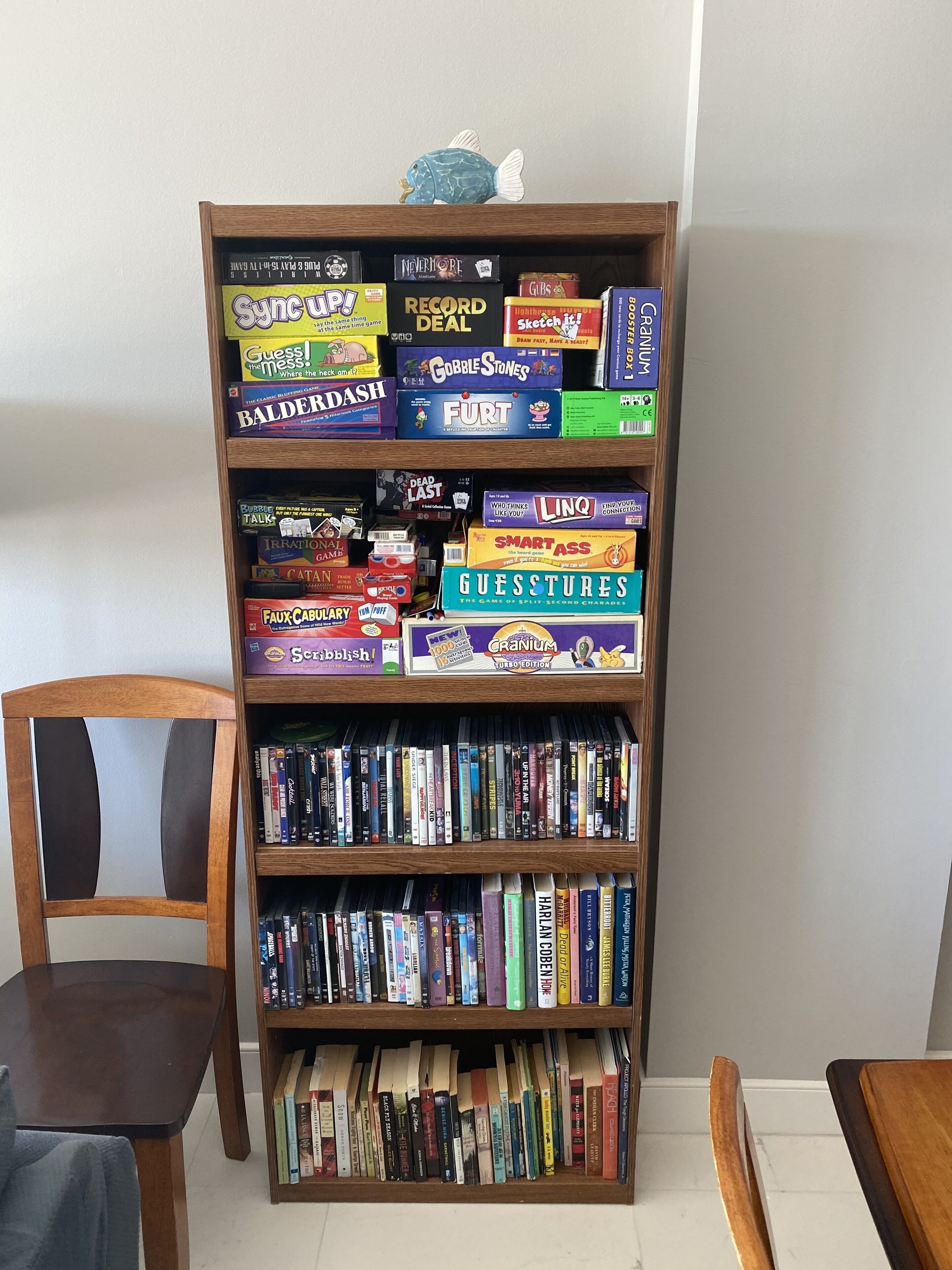 A bookshelf filled with board games and books.