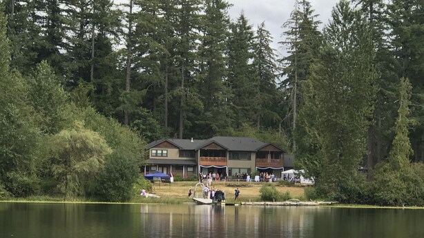 A lodge with a dock extending into a lake, surrounded by dense forest. - Close-in Beautiful Retreat: Large, Lodge-Like Private Lakefront Setting (Renton)