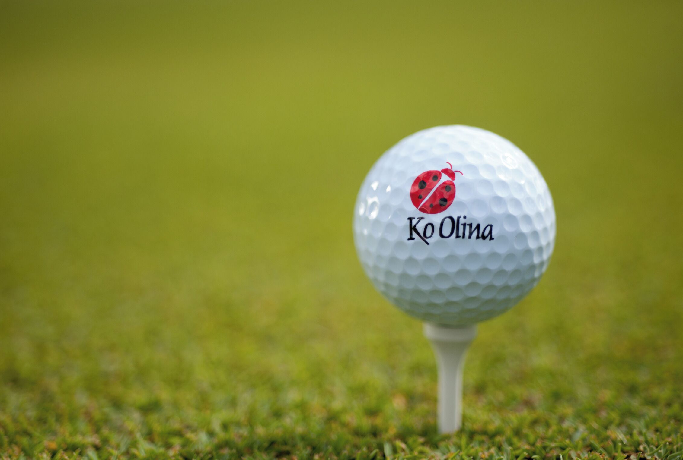 A golf ball with the Ko Olina logo on a tee.