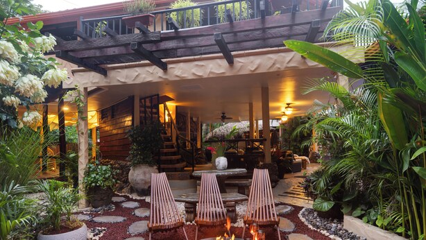 An outdoor seating area with a fire pit, lounge chairs, and a stone pathway. - Casa Melosa Villa in Playa Potrero/Flamingo Costa Rica (Playa Potrero/Flamingo)