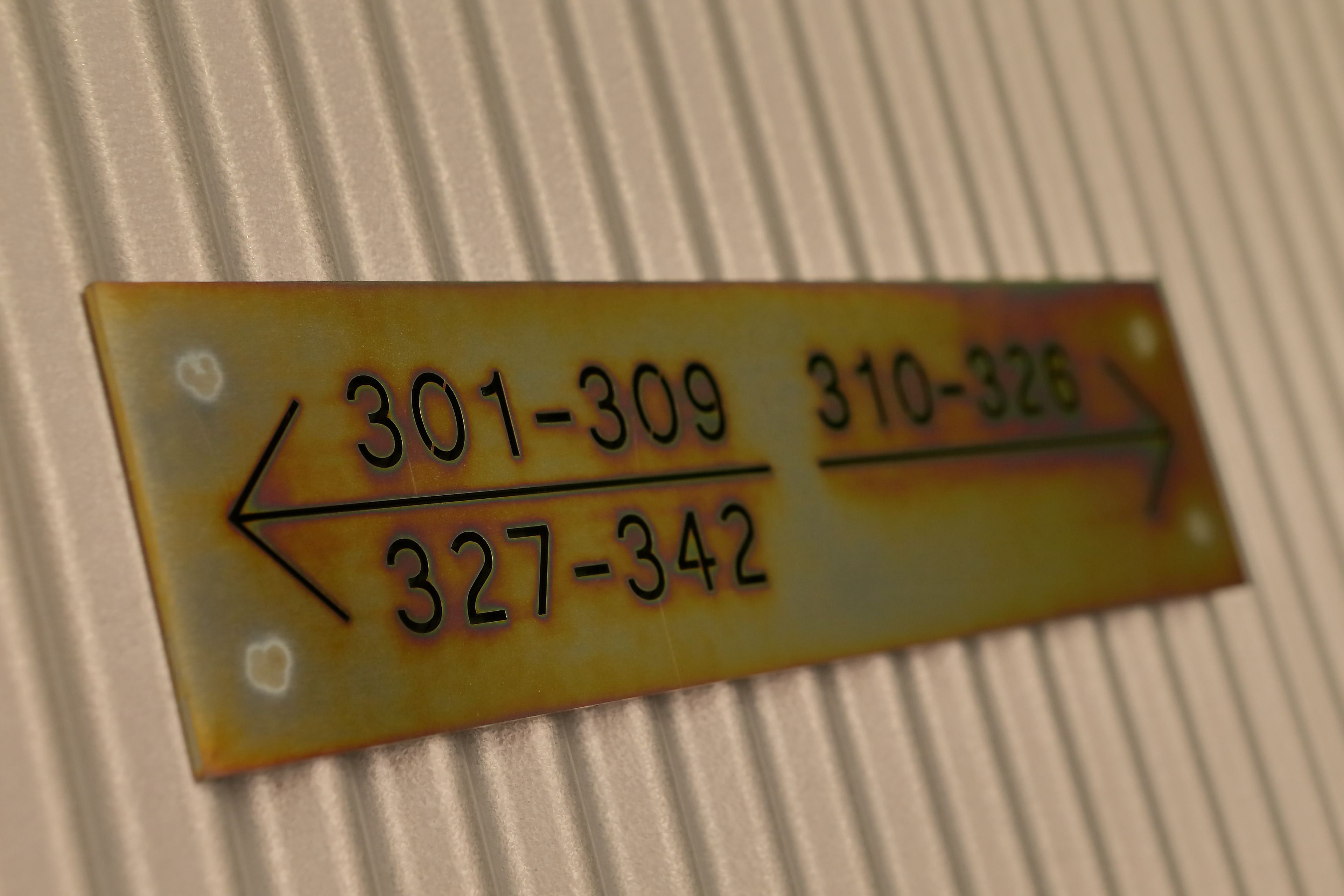 A directional sign with phone numbers.