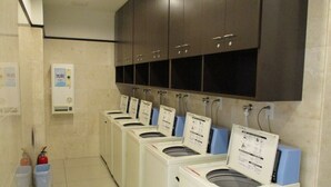 Eine Wäscherei mit mehreren Waschmaschinen und einem Wasserspender.