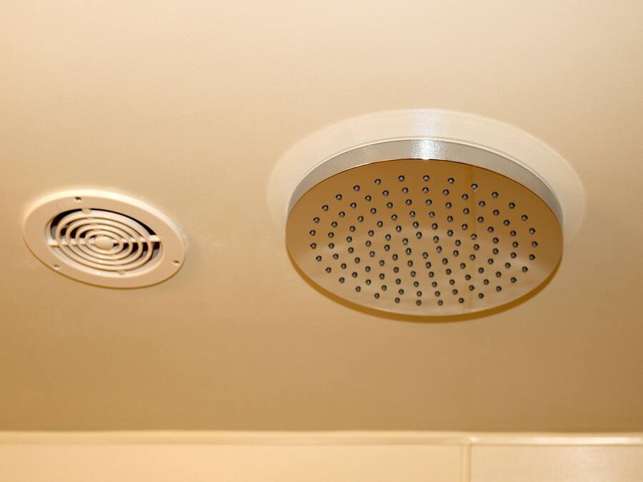 A ceiling with two ventilation grilles.