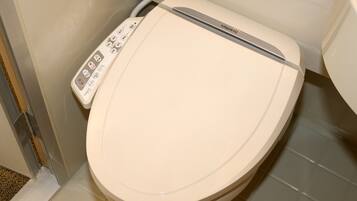 A toilet with a control panel featuring various buttons and a brand name.