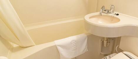 A bathroom with a white sink, a bathtub, and a toilet.