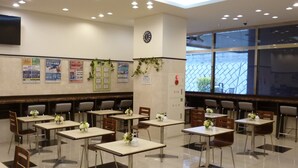 A clean, well-lit dining area with tables and chairs arranged for seating. - Toyoko Inn Odawara Station (Odawara)