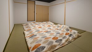 A small, clean room with a single bed, a wardrobe, and a ceiling light. - Machi de kurasu Tengachaya-2 (Osaka)