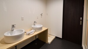 A bathroom with two sinks, a dark door, and a light-colored floor. - Machi de kurasu Tengachaya-2 (Osaka)