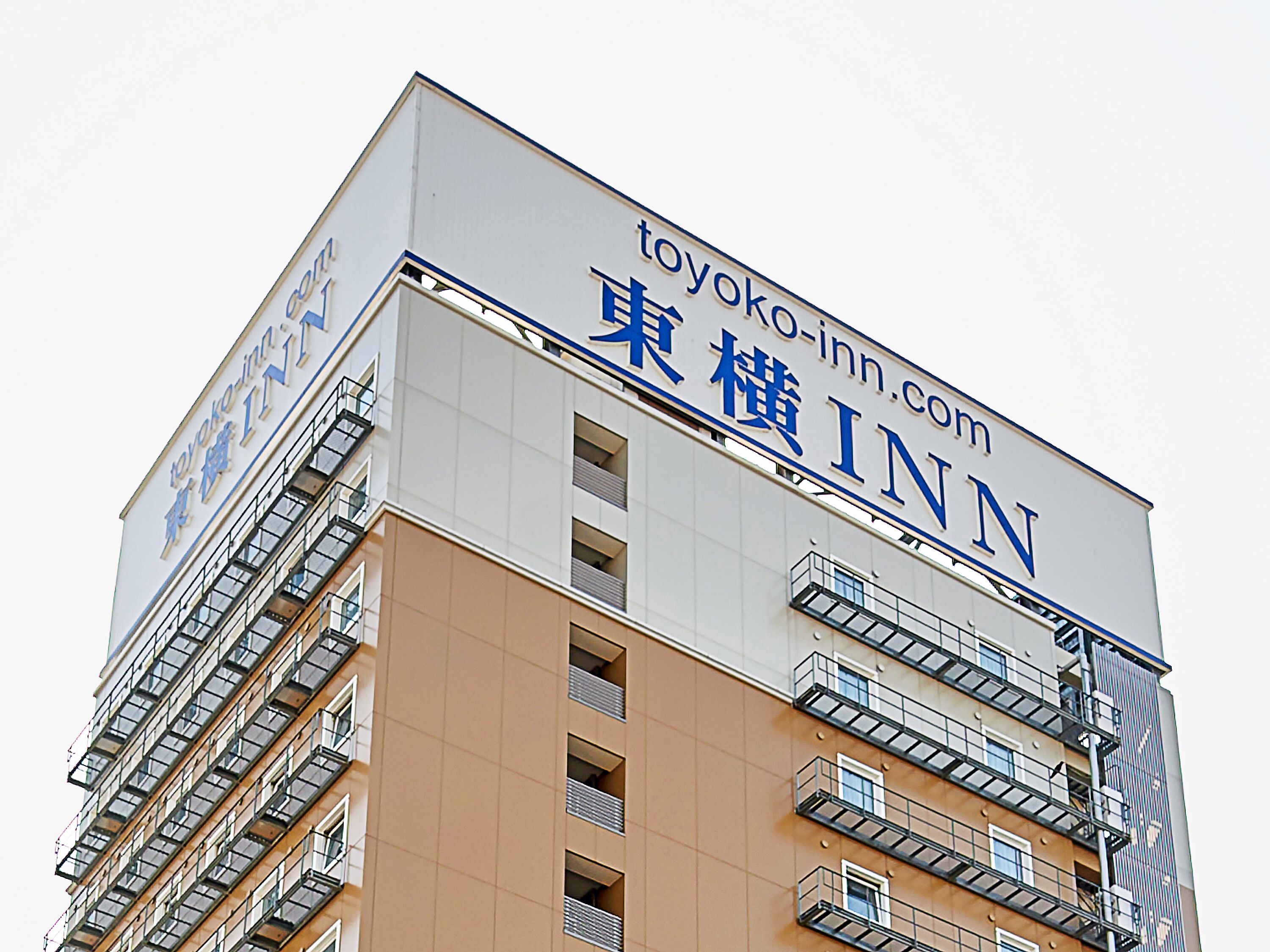 A multi-story building with a sign for Toyoko Inn.