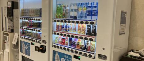 Two vending machines with various beverages and snacks.