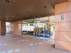 A hotel entrance with a tiled floor, a glass door with signage, and a ceiling with recessed lighting. - Toyoko Inn Kawaguchi Ekimae (Kawaguchi)