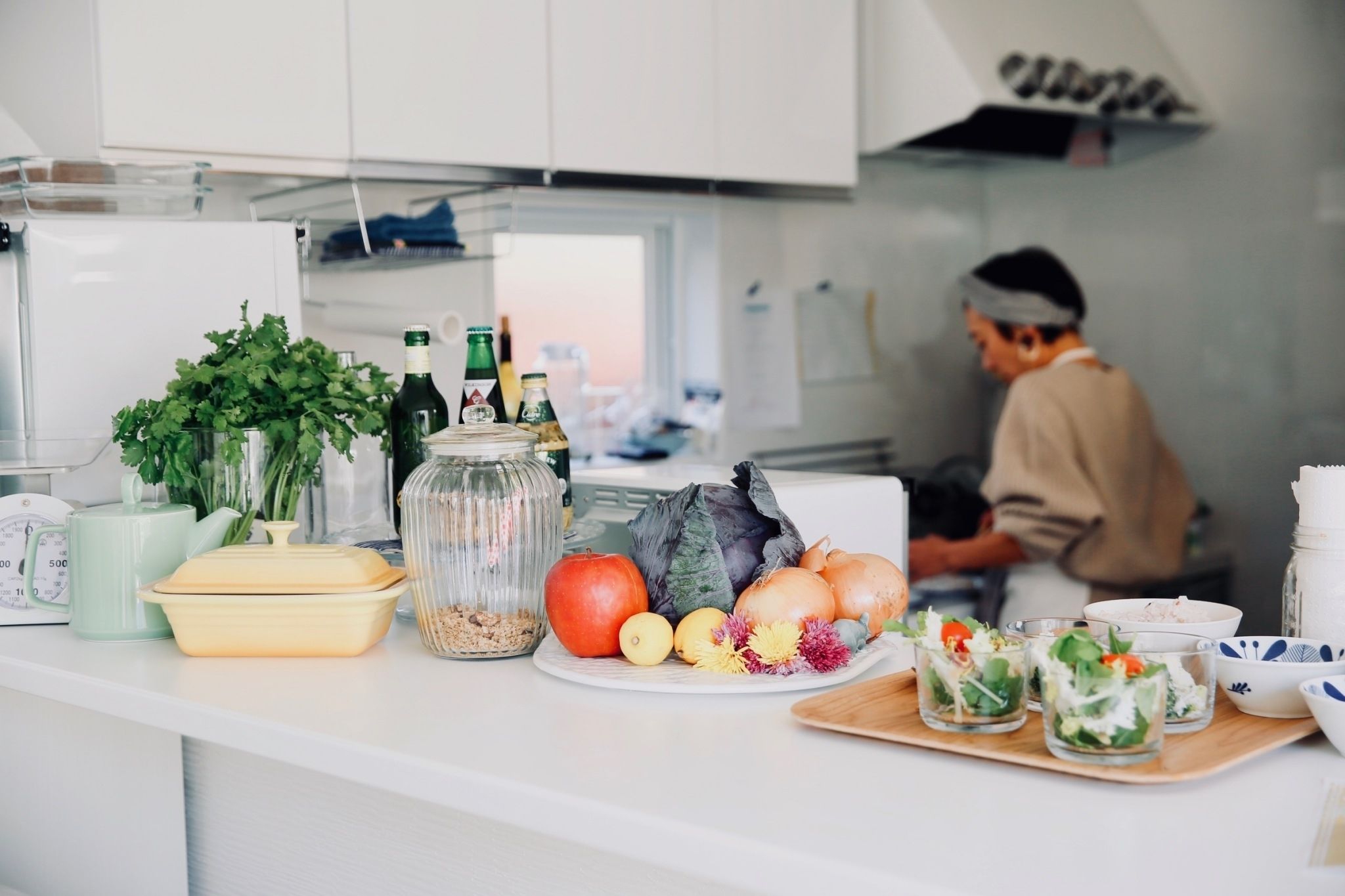 A kitchen counter with various food items and kitchenware.