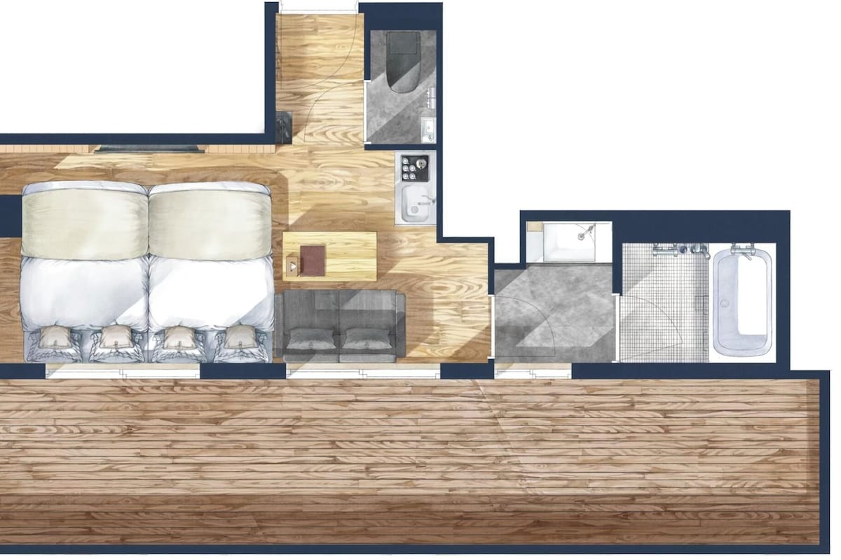 A floor plan of a hotel room with a bed, a sofa, a small table, a bathroom with a bathtub and sink, and a wooden floor.