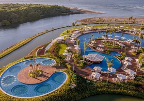 A resort with multiple swimming pools, a marina, and lush greenery. - GRAND LUXXE RESIDENCE CLUB (Nuevo Vallarta)