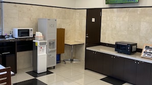 A kitchenette with a microwave, an ice dispenser, a water cooler, a small refrigerator, and a black toaster. - Toyoko Inn Tokyo Keihin Tohoku Line Oji Station Kita (Tokyo)