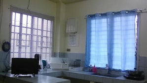 A kitchen with a window, a sink, and a countertop.