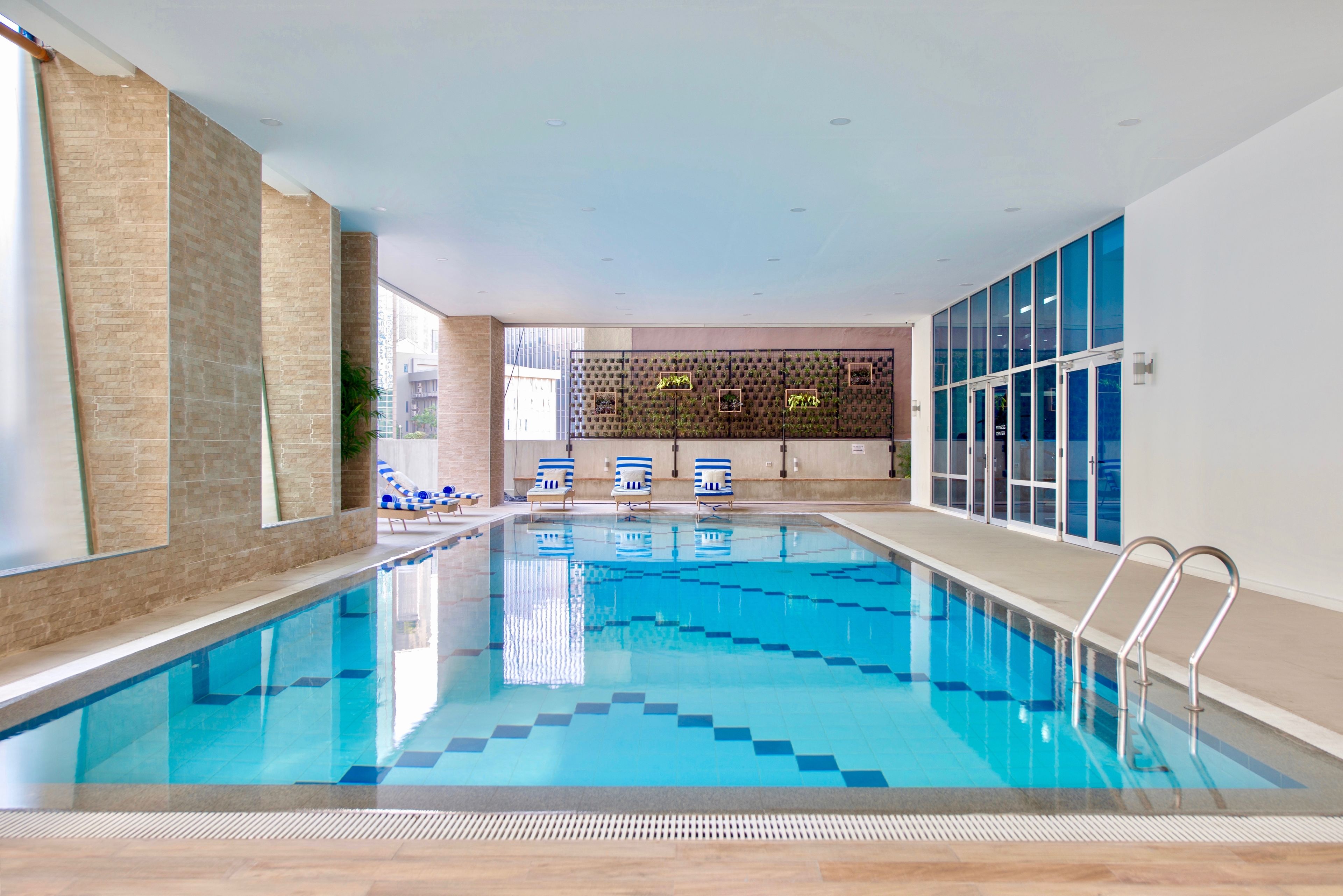 Indoor pool, open 6:00 AM to 10:00 PM, pool loungers