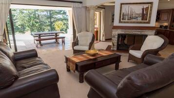 Deluxe House | Living area | Flat-screen TV, fireplace