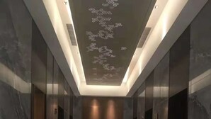 A modern hallway with marble flooring, glass doors, and a ceiling with a light fixture. - Courtyard by Marriott Hangzhou Xiaoshan (Hangzhou)